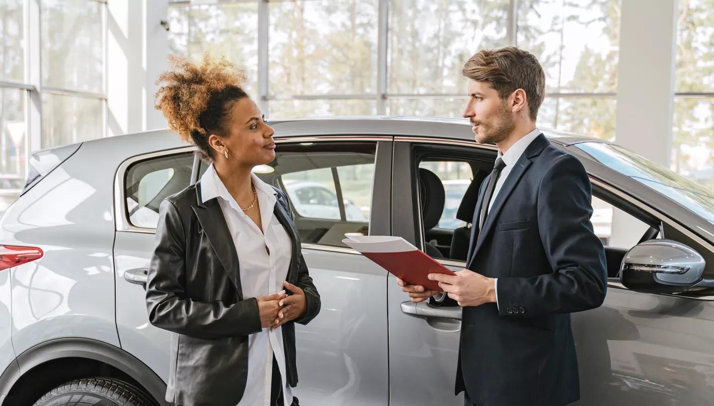 Vendeur de voiture qui conseil une femme